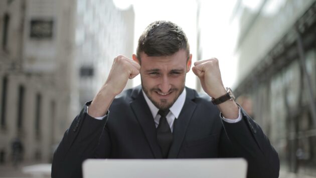 man in black suit achieved an accomplishment