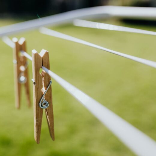 metall clotheshorse with clothespins on green lawn