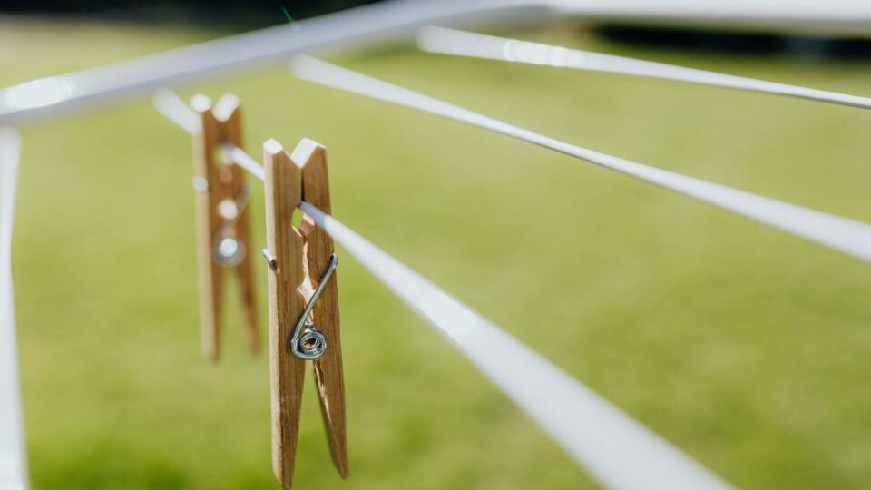 metall clotheshorse with clothespins on green lawn