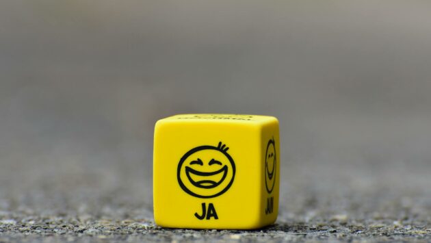 yellow cube on brown pavement