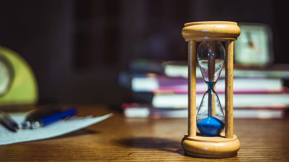 hourglass on brown wooden frame